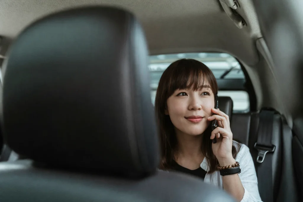 Executive talking on phone in the back seat before a client meeting