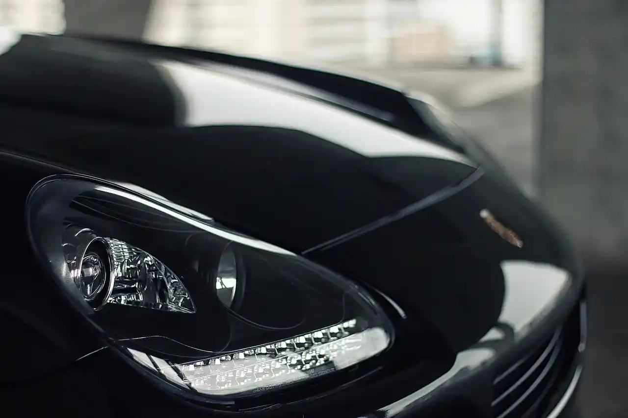 sleek black luxury SUV parked at Seattle-Tacoma International Airport departures lane at sunrise, professional chauffeur opening the rear door, travelers with carry-on luggage, ...