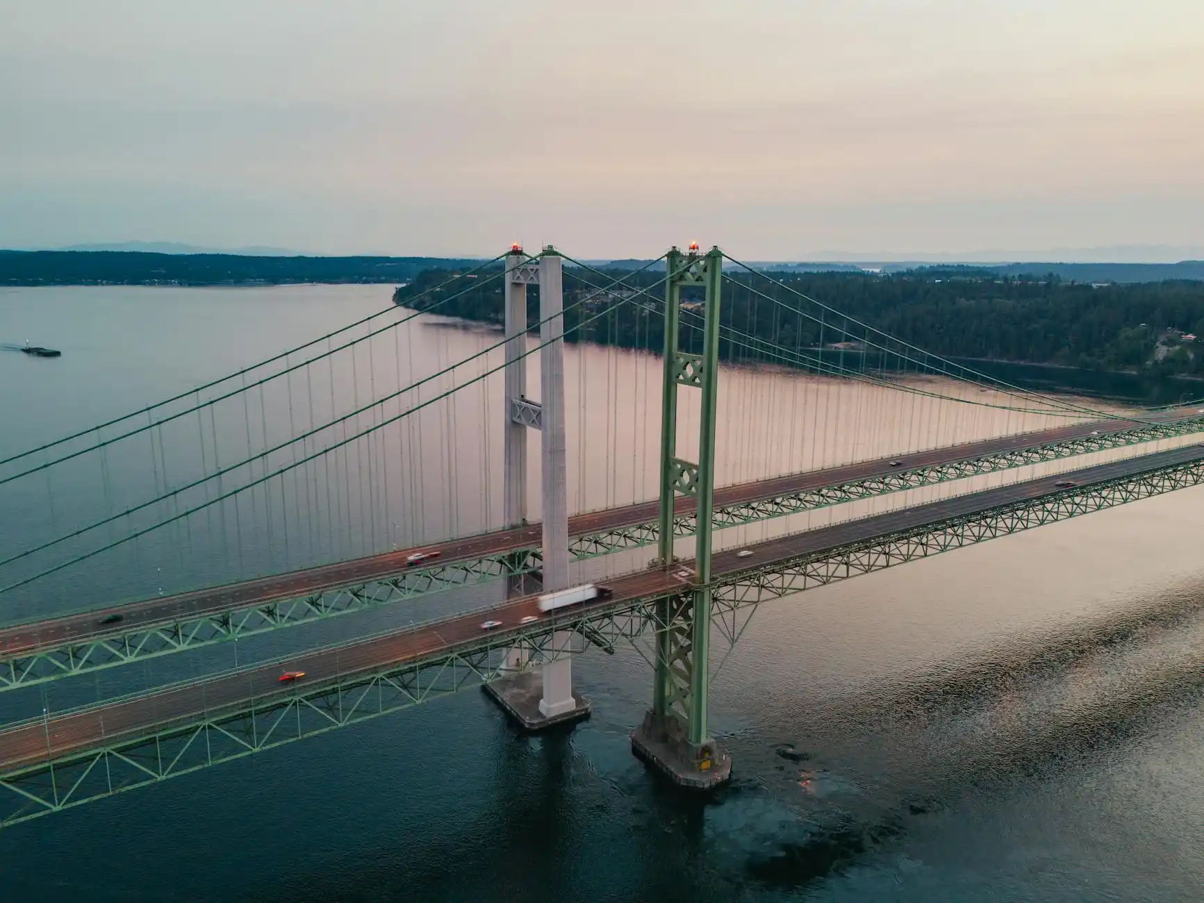 overhead map-style visual of greater Seattle region with highlighted route lines from Seattle, Bellevue, Redmond, and Tacoma to Sea-Tac airport, realistic traffic glow and rainy...