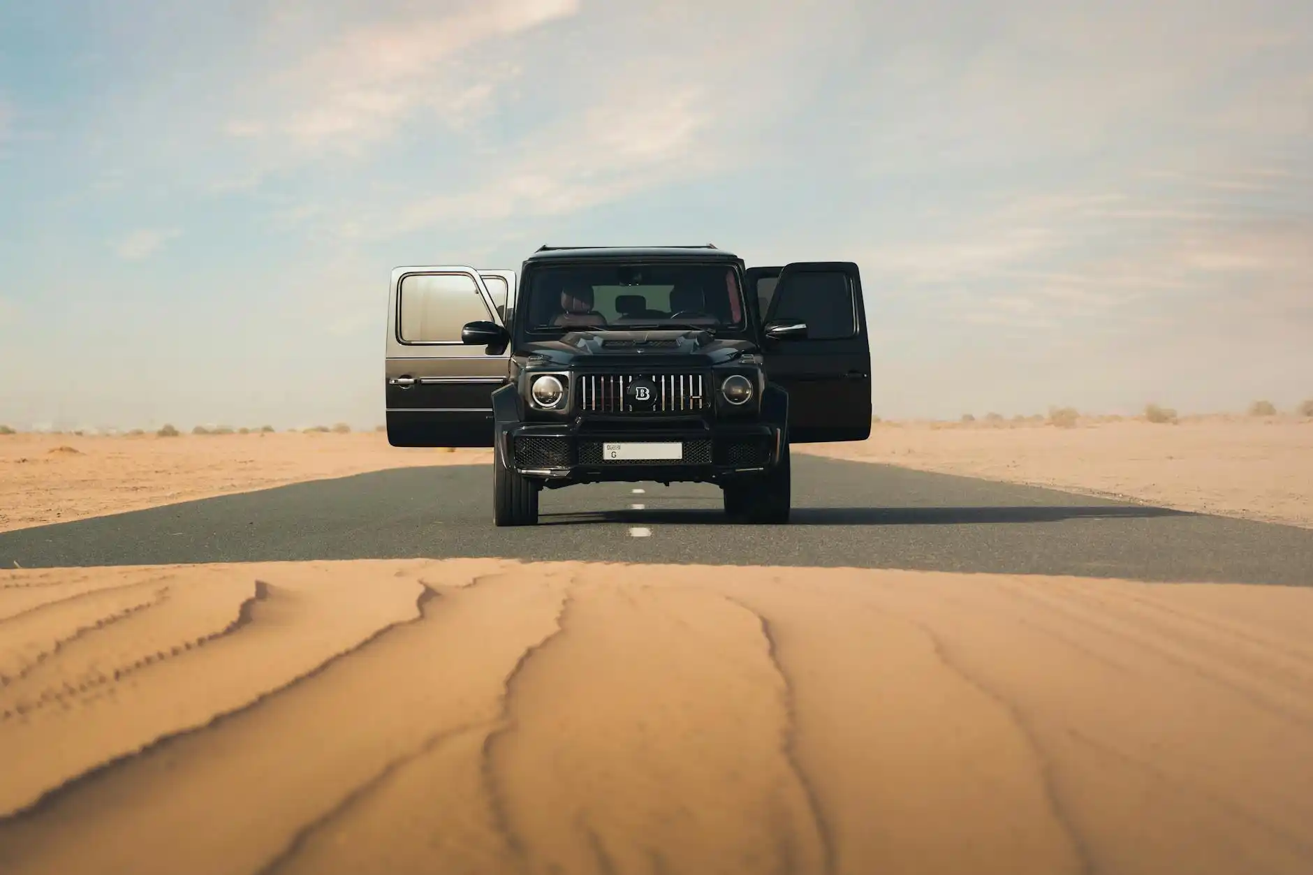 family with two children and luggage being greeted by chauffeur outside a modern suburban Everett home before sunrise, luxury SUV waiting at curb