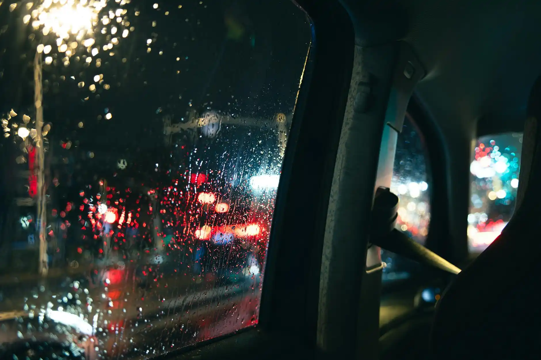 overhead view of a Seattle business district route map on a tablet in the back seat of a luxury car, calendar app open beside coffee and smartphone, rain-speckled window showing...