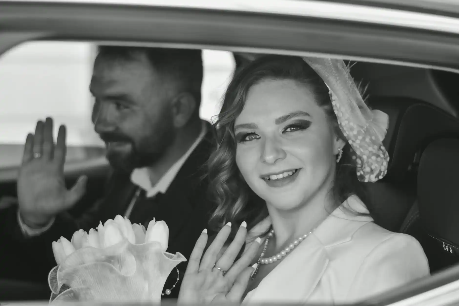 elegant wedding couple and family entering a black Lincoln Navigator outside a downtown Seattle hotel, floral arrangements, evening lighting, formal attire