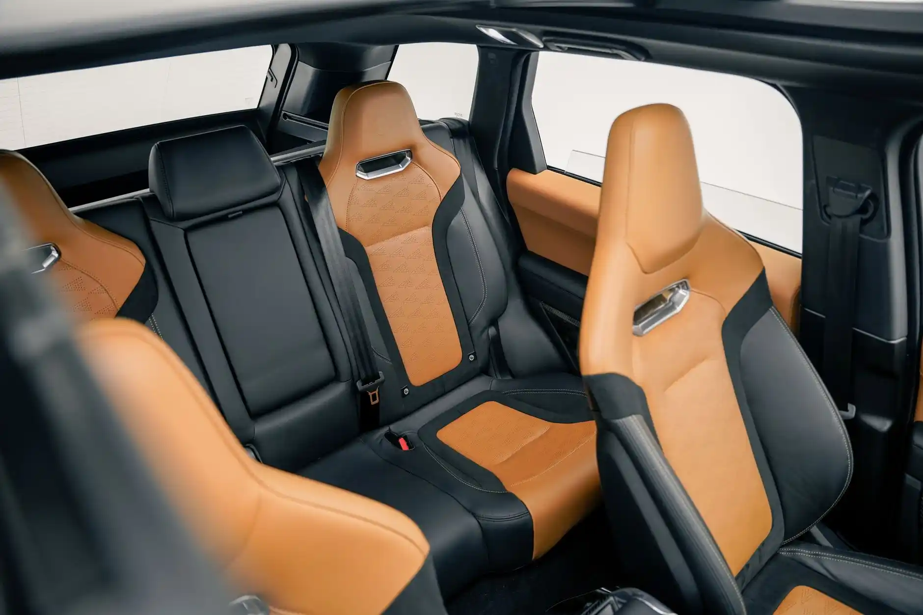 luxurious black SUV interior with leather seats, bottled water, soft ambient lighting, and Seattle skyline visible through tinted windows