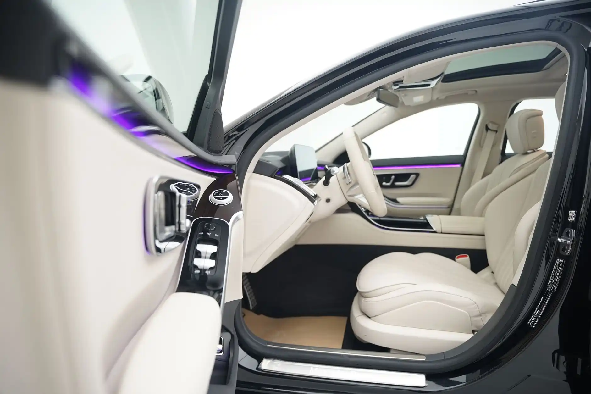 interior of a full-size luxury SUV with six passengers seated comfortably, overhead ambient lighting, leather seats, and stacked suitcases in rear cargo area
