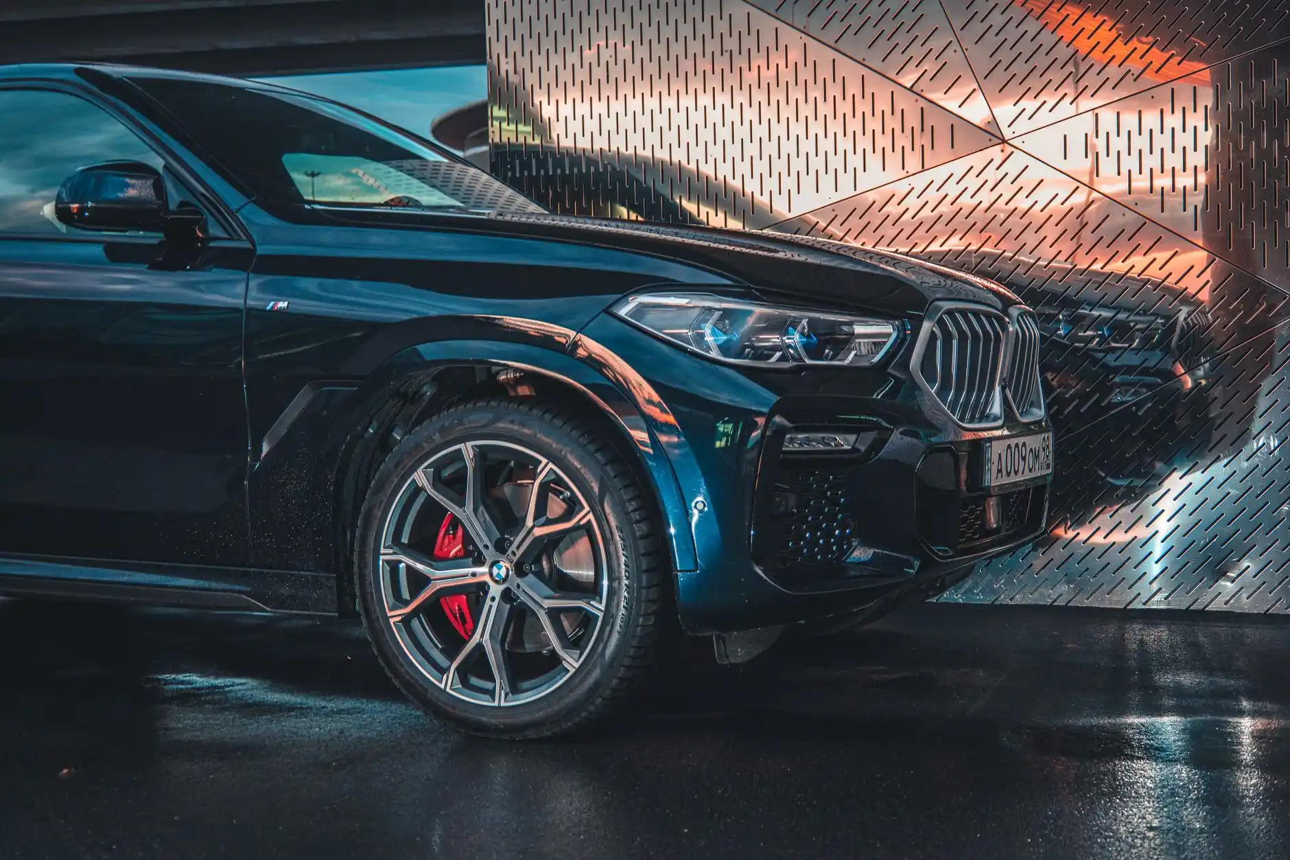 black luxury SUV parked at an airport curb at sunrise, professional chauffeur opening the rear passenger door, travelers with premium luggage, warm golden light reflecting on po...