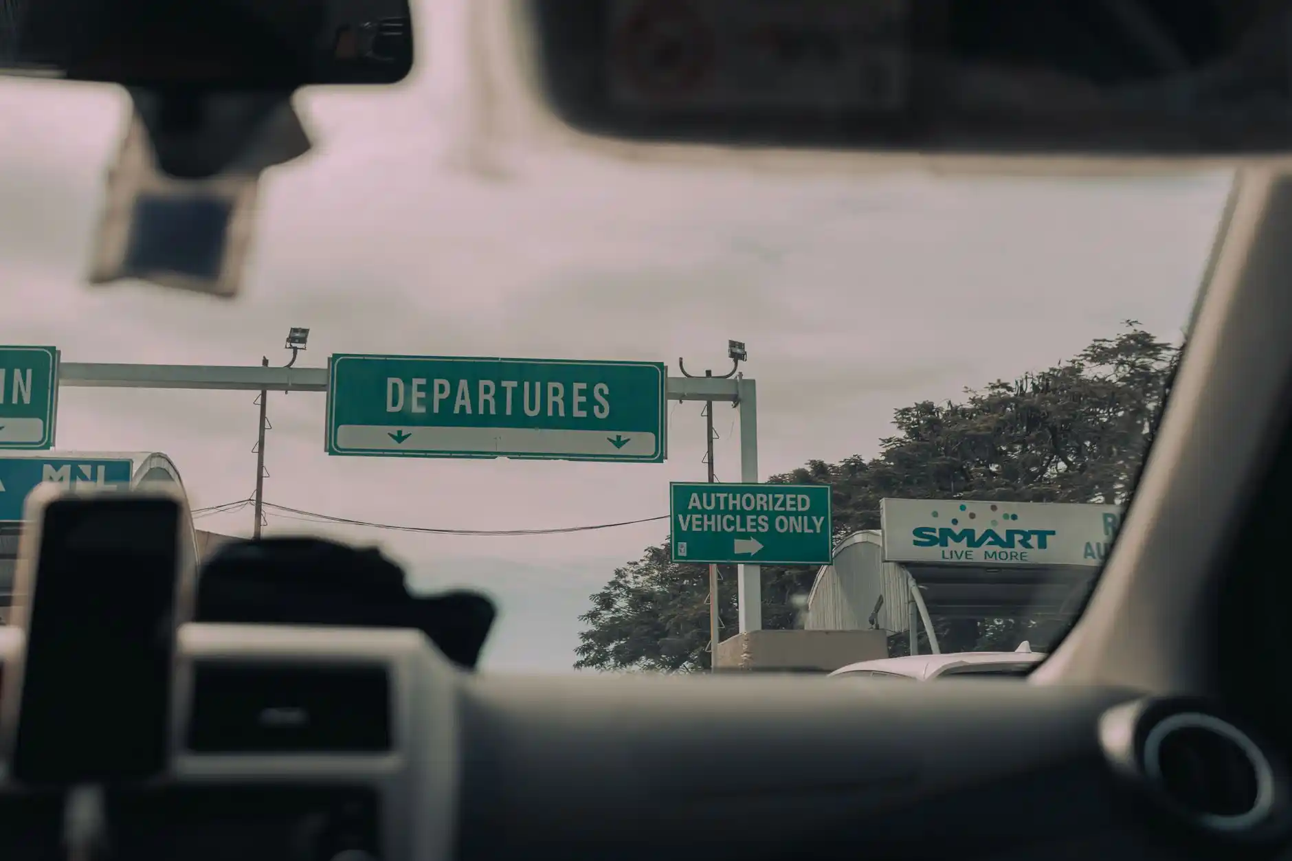 professional black SUV dropping off travelers with rolling luggage at Seattle-Tacoma International Airport departures curb in early morning light, clear terminal signage, realis...