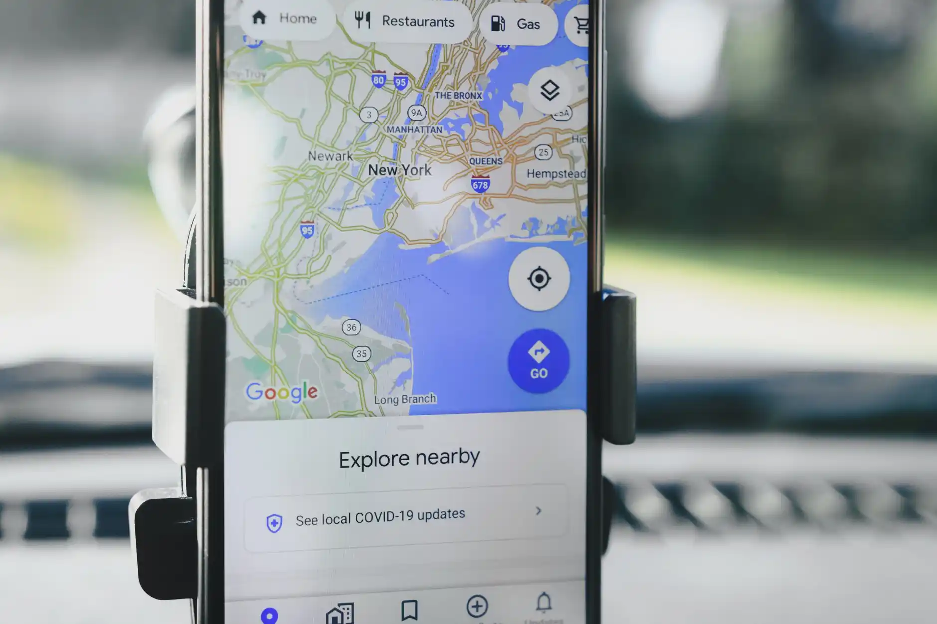 smartphone map showing route from Seattle to Anacortes beside printed ferry schedule and car keys on a clean travel desk