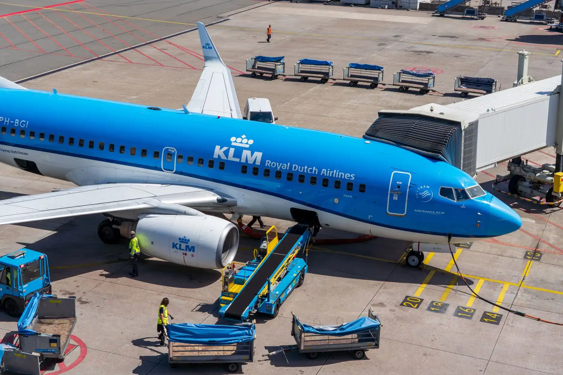 Professional airline crew boarding a black passenger van outside Seattle-Tacoma International Airport, covered terminal pickup area, organized luggage loading, realistic Pacific...