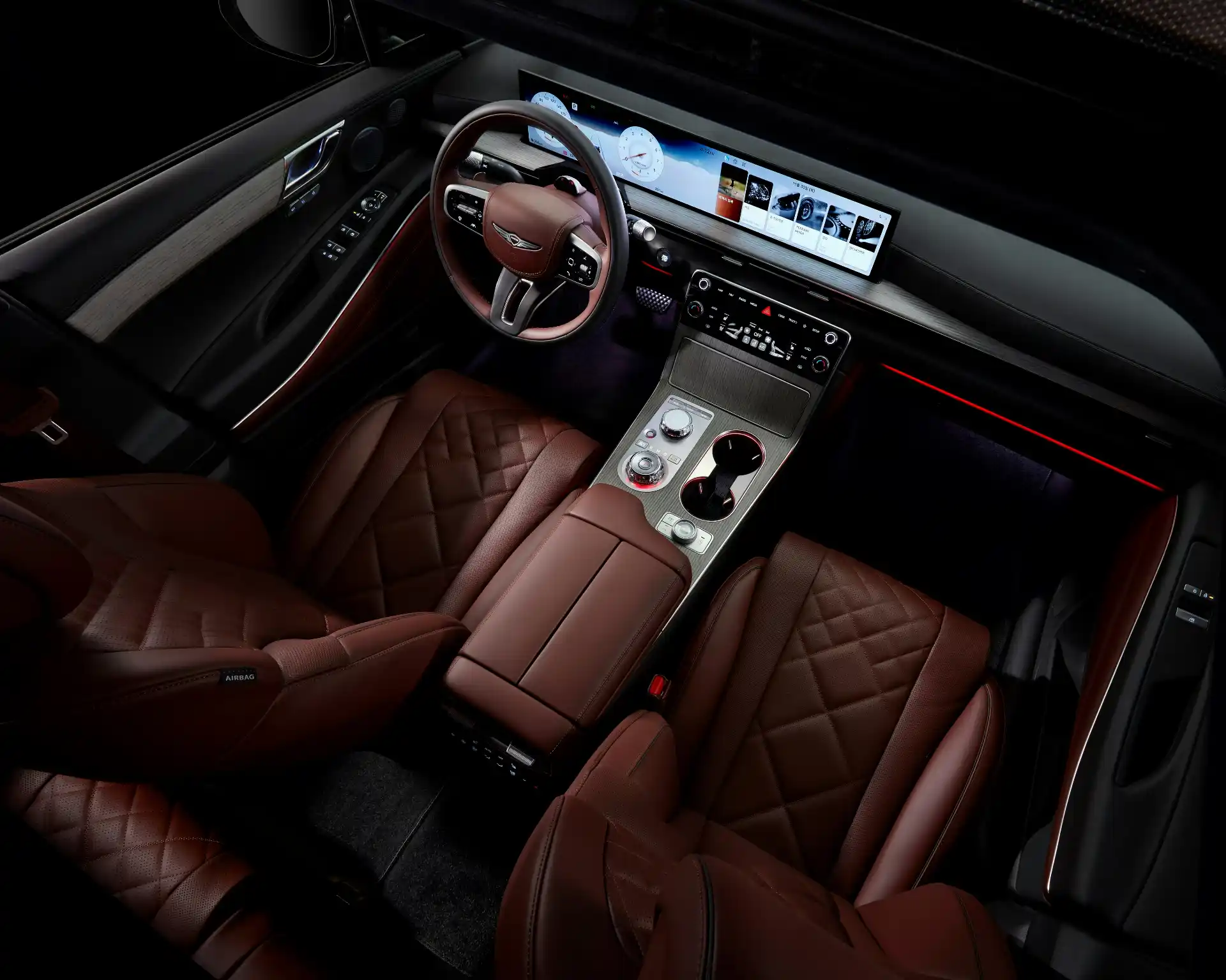 Interior of a premium black SUV showing spacious leather seating, bottled water, neatly arranged luggage area, and subtle ambient lighting