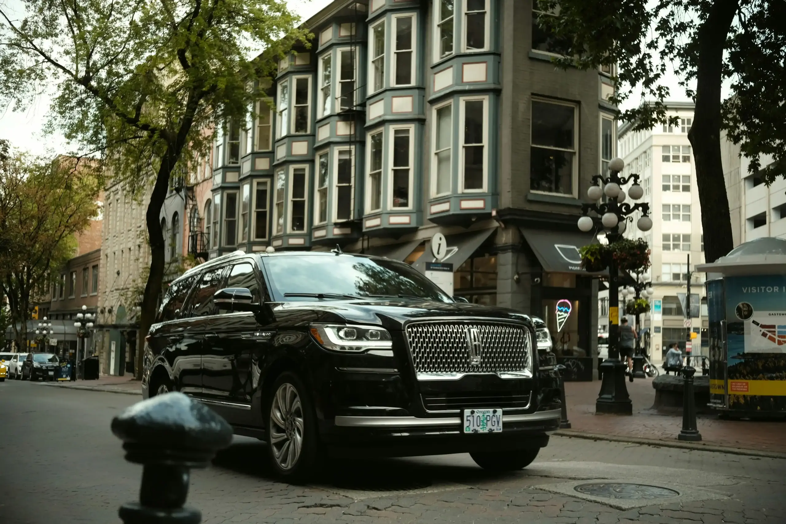 Side-by-side comparison of a black executive sedan, luxury full-size SUV, and stretch limousine with neatly arranged suitcases showing relative luggage capacity